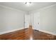 Bedroom with hardwood flooring, neutral wall paint, closet, and base molding at 1631 Fulton Ave, Charlotte, NC 28205