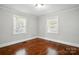 This cozy bedroom features two windows, hardwood flooring, and neutral paint at 1631 Fulton Ave, Charlotte, NC 28205