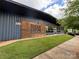 Modern brewery featuring wood accents, glass windows, and manicured lawn on a sunny day at 1631 Fulton Ave, Charlotte, NC 28205