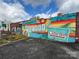 Calle Sol's vibrant building exterior featuring colorful murals, and a Latin Cafe at 1631 Fulton Ave, Charlotte, NC 28205