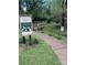 Plaza Midwood Community Garden featuring a walking path and small bridge over creek in a green space at 1631 Fulton Ave, Charlotte, NC 28205