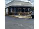 Charming bakery exterior with black and white striped awning and outdoor seating on a sunny day at 1631 Fulton Ave, Charlotte, NC 28205