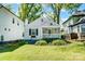 Charming cottage-style home with a welcoming front porch, lush lawn, and beautiful landscaping at 1631 Fulton Ave, Charlotte, NC 28205