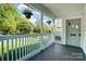 Inviting covered front porch with hanging flower baskets overlooking a green lawn at 1631 Fulton Ave, Charlotte, NC 28205