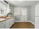 Cozy kitchen featuring white appliances and ample cabinet space at 1631 Fulton Ave, Charlotte, NC 28205