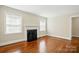 Bright living room featuring hardwood floors, a fireplace, and plenty of natural light at 1631 Fulton Ave, Charlotte, NC 28205