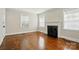 Inviting living room boasts a classic fireplace and gleaming hardwood floors at 1631 Fulton Ave, Charlotte, NC 28205
