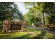Stone sign for historic Plaza Midwood neighborhood surrounded by trees at 1631 Fulton Ave, Charlotte, NC 28205