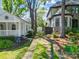 Side yard view of the cottage home showing a driveway and a detached garage at 1631 Fulton Ave, Charlotte, NC 28205