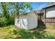 Exterior view of a white storage shed in the backyard surrounded by greenery at 1631 Fulton Ave, Charlotte, NC 28205