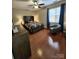Comfortable bedroom featuring a ceiling fan, wood flooring, and natural light from the window at 18224 Taffrail Way, Cornelius, NC 28031