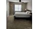A comfortable bedroom featuring a bed, carpet, window, and bedside table at 18224 Taffrail Way, Cornelius, NC 28031
