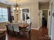 Elegant dining room with hardwood floors, a modern chandelier, and neutral paint colors at 18224 Taffrail Way, Cornelius, NC 28031