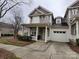 Inviting two-story townhouse with a covered porch and attached one car garage and cozy landscaping at 18224 Taffrail Way, Cornelius, NC 28031