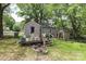 Backyard featuring a deck with seating, storage shed, and landscaping at 1900 Union St, Charlotte, NC 28205