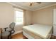Well-lit bedroom with wood floors, a ceiling fan, and a large window creating a bright and welcoming space at 1900 Union St, Charlotte, NC 28205