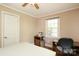 Functional bedroom with wood floors, a ceiling fan, a window, and a small desk, suited for work and relaxation at 1900 Union St, Charlotte, NC 28205