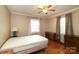 Inviting bedroom with wood floors, a ceiling fan, and traditional furnishings offering comfort and a serene ambiance at 1900 Union St, Charlotte, NC 28205