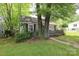 Exterior view shows a gray home and lawn shaded by mature trees at 1900 Union St, Charlotte, NC 28205