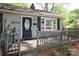 Charming front porch with gray railings leads to the front door of the gray brick home at 1900 Union St, Charlotte, NC 28205