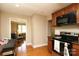 Cozy kitchen with wood cabinets, contrasting countertops, and an open doorway to the living area enhancing the home's flow at 1900 Union St, Charlotte, NC 28205