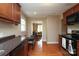 Traditional kitchen featuring warm wood cabinets and granite countertops, seamlessly flowing into the adjacent living area at 1900 Union St, Charlotte, NC 28205