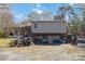 Backyard of a two-story home with a garage, featuring a covered patio and ample space at 1923 Tracy Ct, Fort Mill, SC 29708