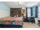 A cozy bedroom with colorful bedspread, desk, and light blue walls at 1923 Tracy Ct, Fort Mill, SC 29708