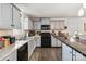 Bright kitchen with gray cabinets, black appliances, and dark countertops at 1923 Tracy Ct, Fort Mill, SC 29708