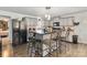 Modern kitchen island with bar stool seating and black appliances, perfect for casual dining and entertaining at 1923 Tracy Ct, Fort Mill, SC 29708