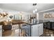Open floor plan showcasing the living room and kitchen island with seating at 1923 Tracy Ct, Fort Mill, SC 29708