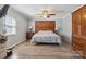The main bedroom featuring hardwood floors, a ceiling fan, and custom headboard at 1923 Tracy Ct, Fort Mill, SC 29708