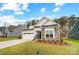 Charming home with stone accents, a well-maintained lawn, and a two-car garage at 2003 Mantle Ridge Dr # 191, Wesley Chapel, NC 28079