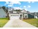 Charming exterior of a single-Gathering home with a well-manicured lawn and a two-car garage at 2003 Mantle Ridge Dr # 191, Wesley Chapel, NC 28079