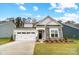 Beautiful single-story home featuring stone accents, a two-car garage, and manicured landscaping at 2003 Mantle Ridge Dr # 191, Wesley Chapel, NC 28079