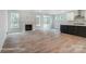 Bright living room with hardwood floors, a fireplace, and large windows offering ample natural light at 2003 Mantle Ridge Dr # 191, Wesley Chapel, NC 28079