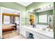 Well lit bathroom featuring a double sink vanity, mirror, and doorway access to the main bedroom at 2014 Arbor Crest Ct, Charlotte, NC 28262