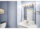 Powder room features a vanity, framed mirror, and decorative lighting at 2014 Arbor Crest Ct, Charlotte, NC 28262
