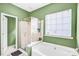Bright bathroom with a glass shower and soaking tub at 2014 Arbor Crest Ct, Charlotte, NC 28262