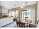 Bright, sunny dining area with access to the backyard and view of the living room with fireplace at 2014 Arbor Crest Ct, Charlotte, NC 28262