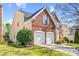 Beautiful brick home featuring a two-car garage, manicured lawn and partial view of a charming entrance at 2014 Arbor Crest Ct, Charlotte, NC 28262