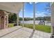 Covered back porch with tiled floor overlooking a scenic lake view and lush green backyard at 2045 Driftwood Cir, Fort Mill, SC 29708