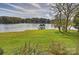 Picturesque backyard featuring lush greenery, a serene lake view, and a charming covered dock at 2045 Driftwood Cir, Fort Mill, SC 29708