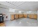 Spacious basement with epoxy floor, wooden cabinetry, and mini refrigerator ready for storage and entertaining at 2045 Driftwood Cir, Fort Mill, SC 29708
