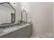Bathroom boasting dual sinks with granite countertops and modern lighting at 2045 Driftwood Cir, Fort Mill, SC 29708