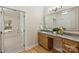 Well-lit bathroom featuring granite countertop vanity, a large mirror, and a walk-in shower at 2045 Driftwood Cir, Fort Mill, SC 29708