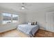 Bright bedroom with scenic lake view, hardwood floors, neutral colors, and a ceiling fan at 2045 Driftwood Cir, Fort Mill, SC 29708