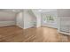 A spacious bedroom with hardwood floors, large windows, and built-in shelving at 2045 Driftwood Cir, Fort Mill, SC 29708