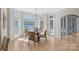 Bright dining area featuring a chandelier, lake views, and access to the outdoor patio through french doors at 2045 Driftwood Cir, Fort Mill, SC 29708