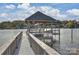 Lake view from the dock showing its construction and neighborhood in the background at 2045 Driftwood Cir, Fort Mill, SC 29708